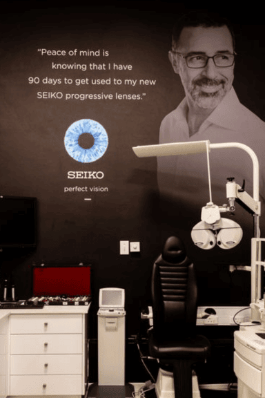 Optometry consultation room with SEIKO progressive lenses branding and equipment at Dynamic Vision practice