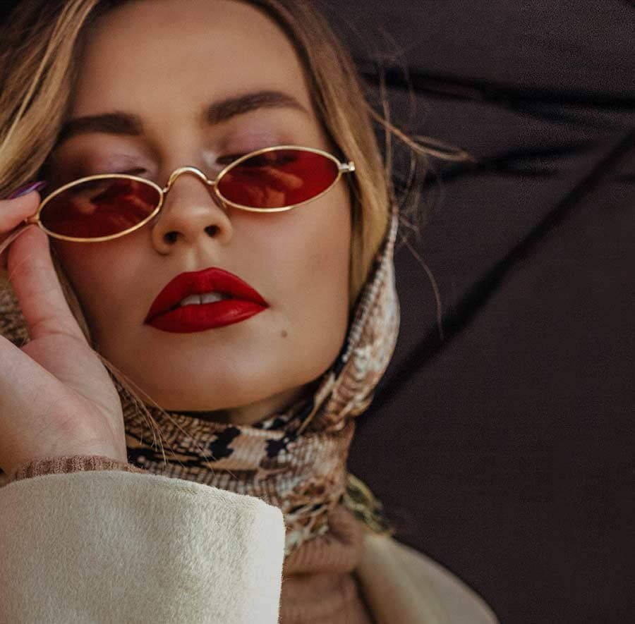 A glamourous female wearing a pair of chic sunglasses from Dynamic Vision Optometrists