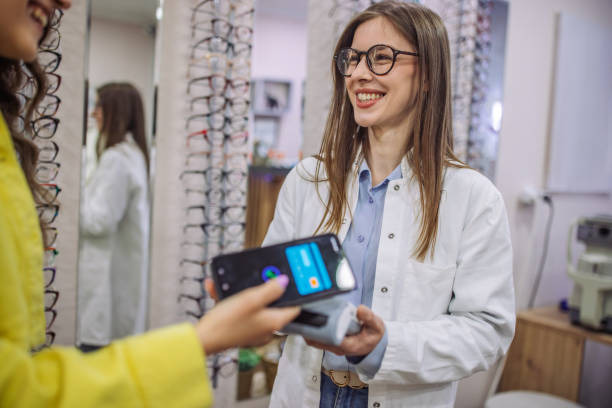 Lady making a Pay Just Now eyewear payment at Dynamic Vision South Africa.