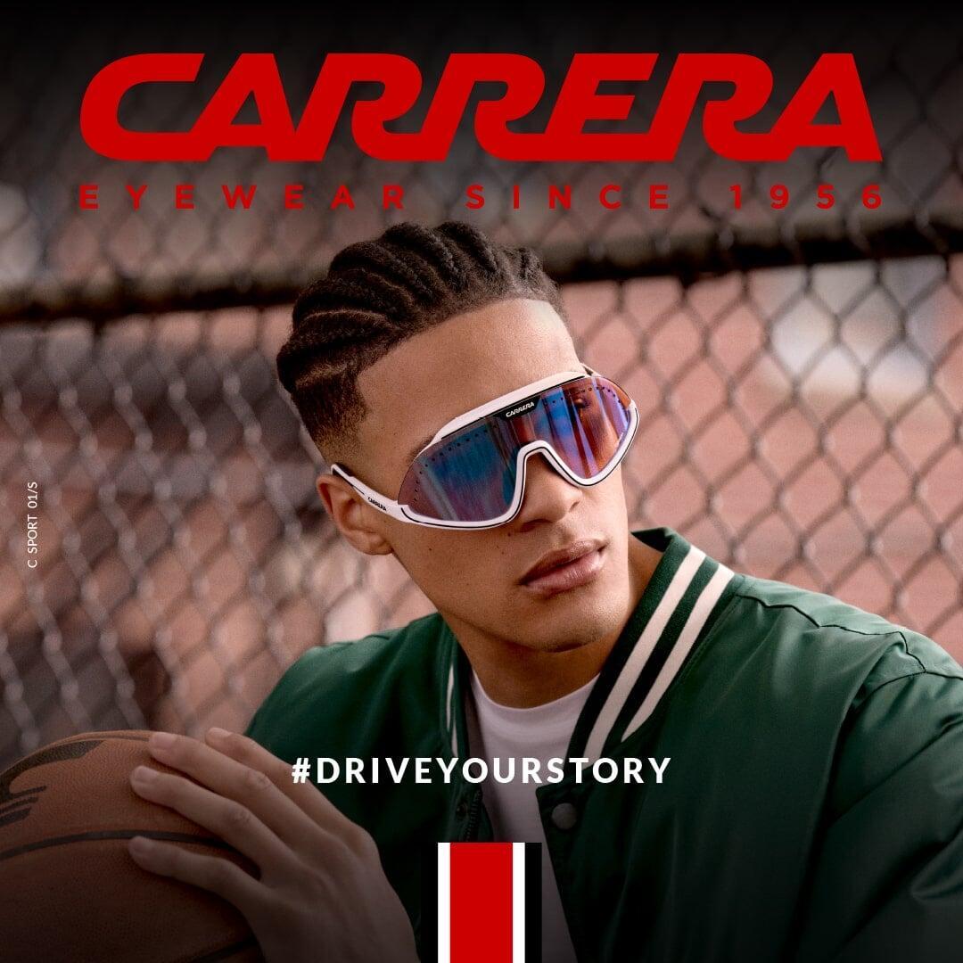 Stylish man in urban setting wearing Carrera sunglasses, representing modern eyewear fashion.