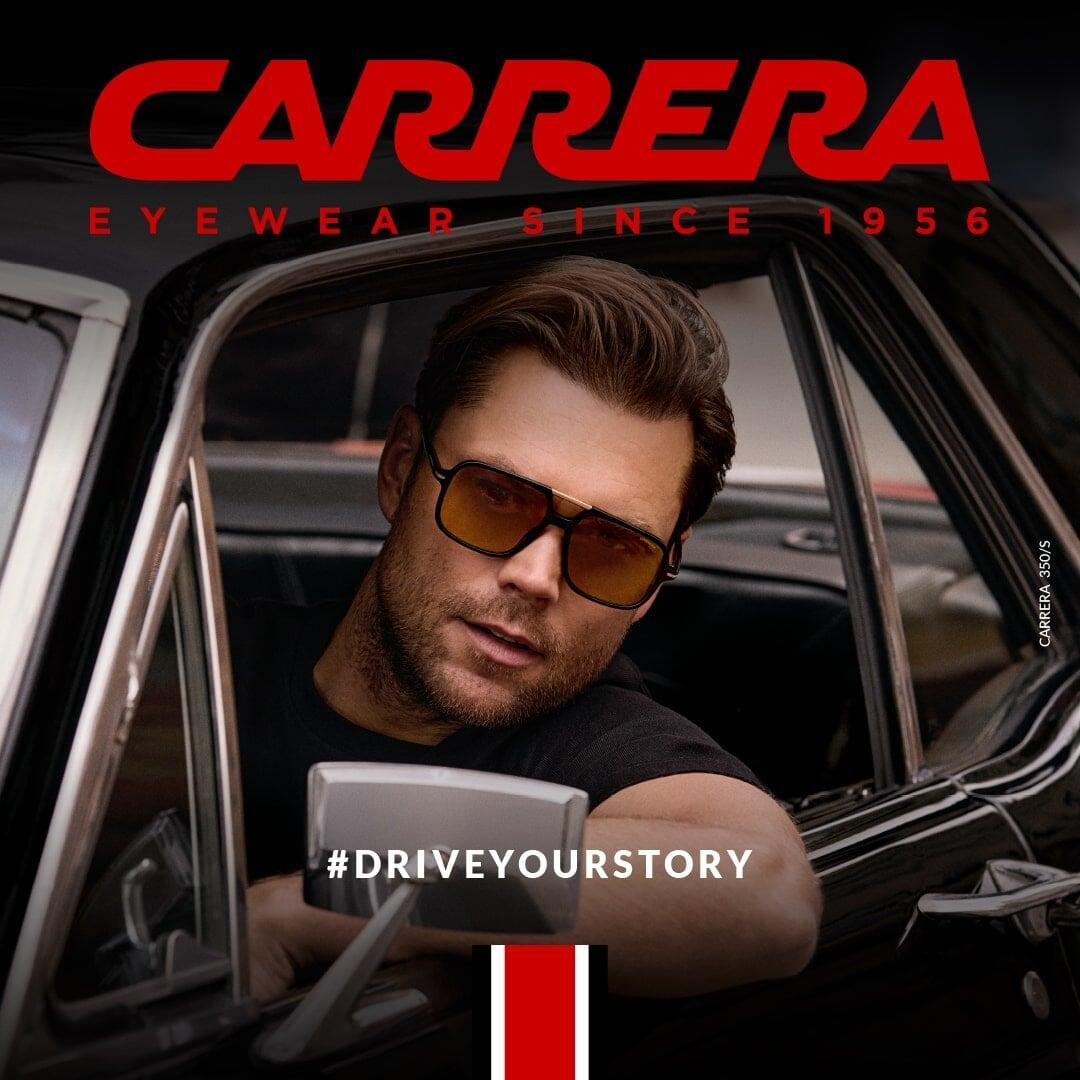 Man wearing Carrera sunglasses outdoors, showcasing a bold lifestyle look.