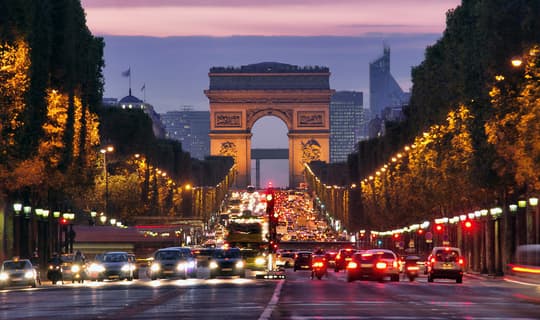 Paris street scene at dusk showing clear, sharp vision through SEIKO Anti-Reflection Coating lenses, available at Dynamic Vision Optometrists in South Africa